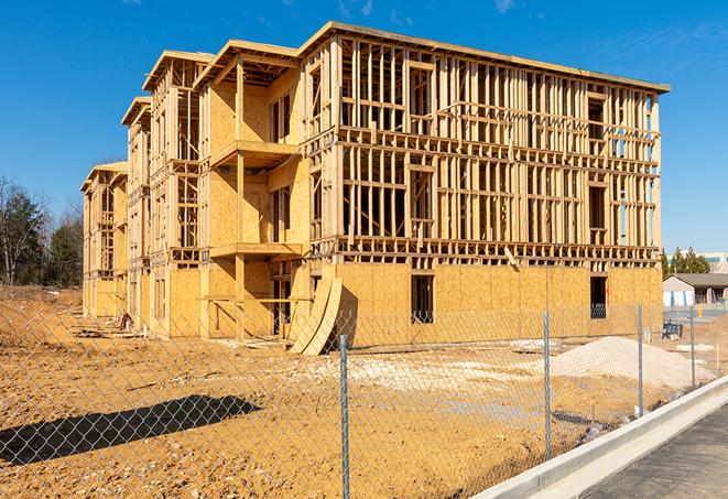 workers protected by temporary barrier fence during building maintenance in Richton Park IL